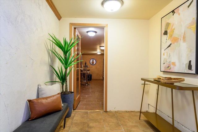 a view of a hallway with seating area