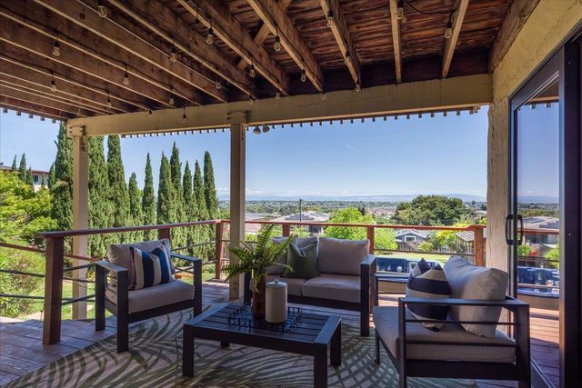 a view of a chairs and table on the deck