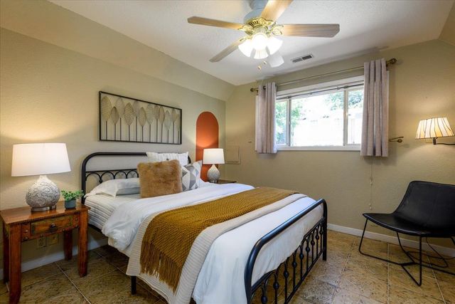 a view of walk in closet with clothes