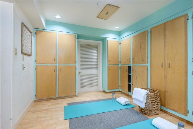 a utility room with granite countertop a sink and a washer