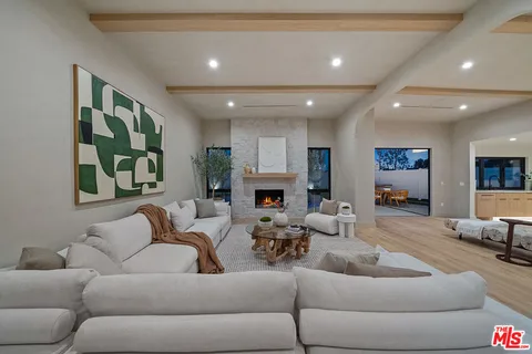 a living room with furniture fireplace and window