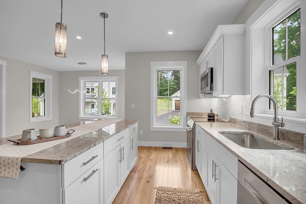 111 Squannacook Road Shirley, MA 01464 - Photo 13 of 22 a kitchen with granite countertop a sink a counter space appliances and cabinets