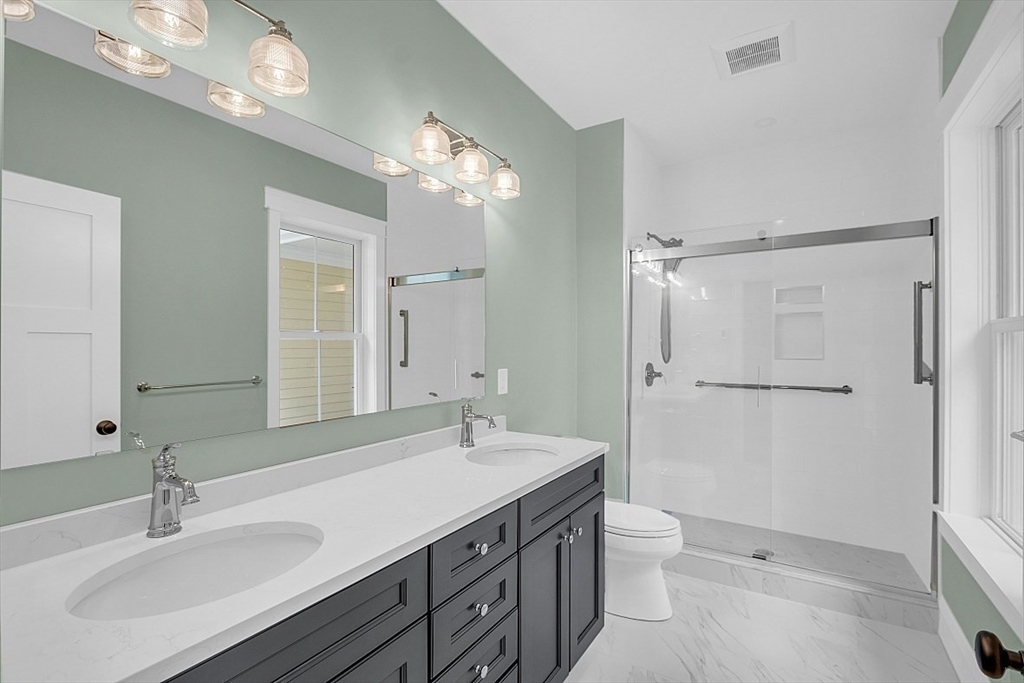 111 Squannacook Road Shirley, MA 01464 - Photo 15 of 22 a bathroom with a double vanity sink mirror and toilet
