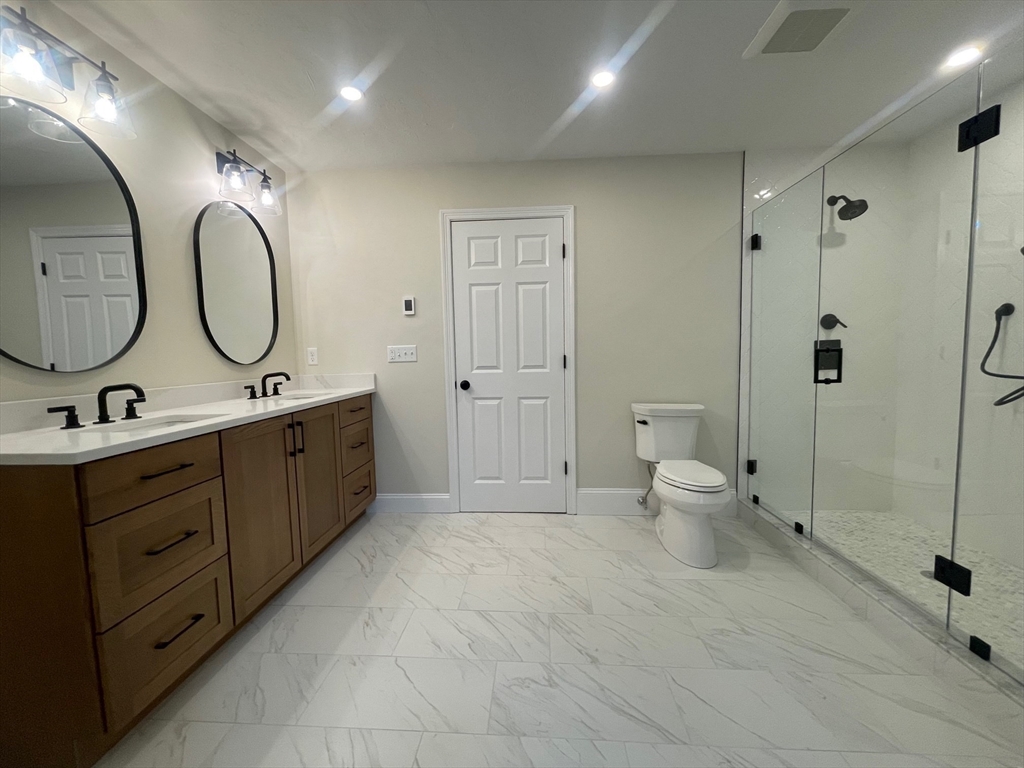 111 Squannacook Road Shirley, MA 01464 - Photo 20 of 22 a spacious bathroom with a double vanity sink toilet mirror and shower