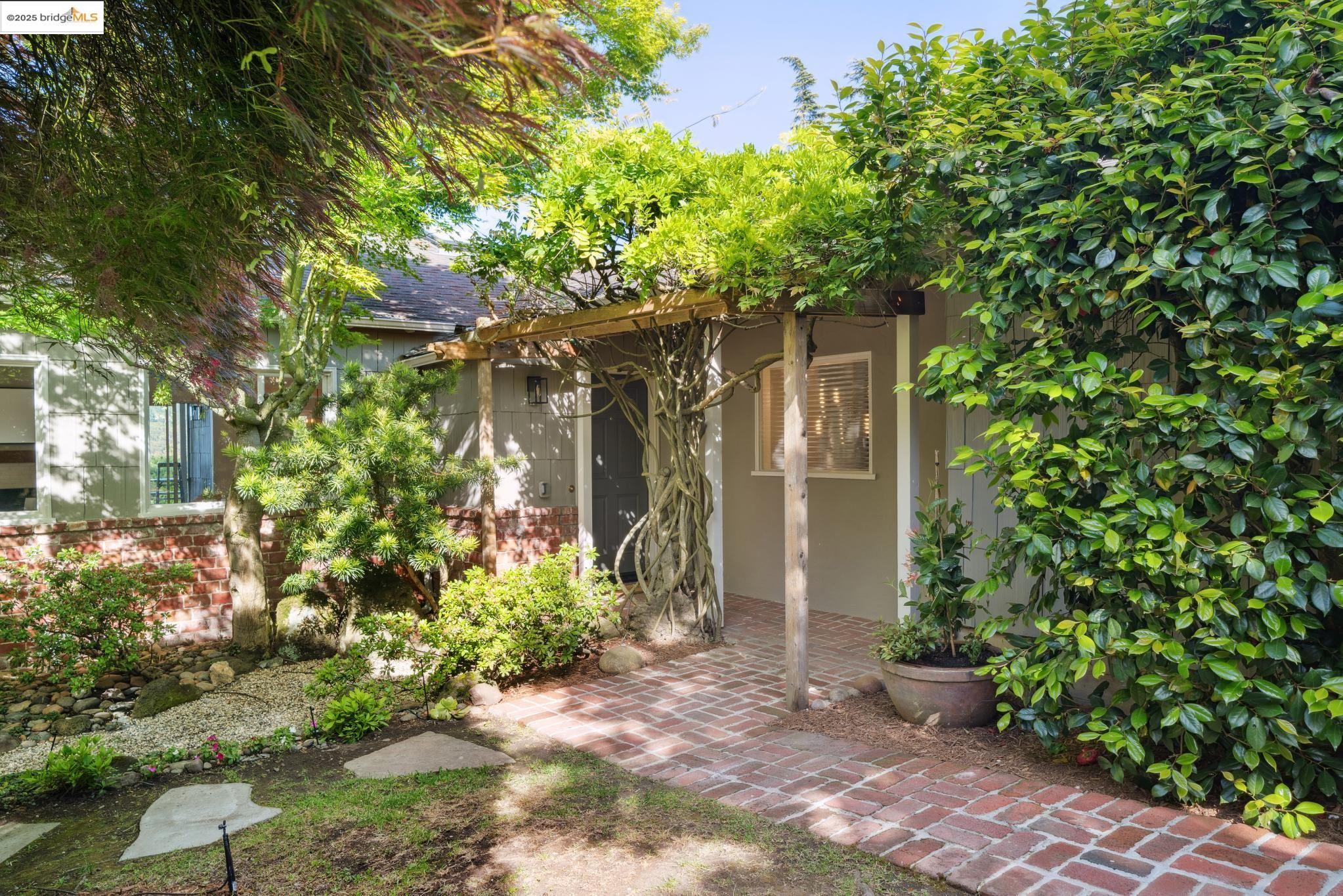 a front view of a house with a tree
