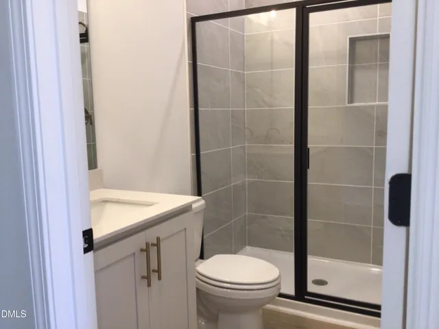 a room with wooden floor a fire place and a window