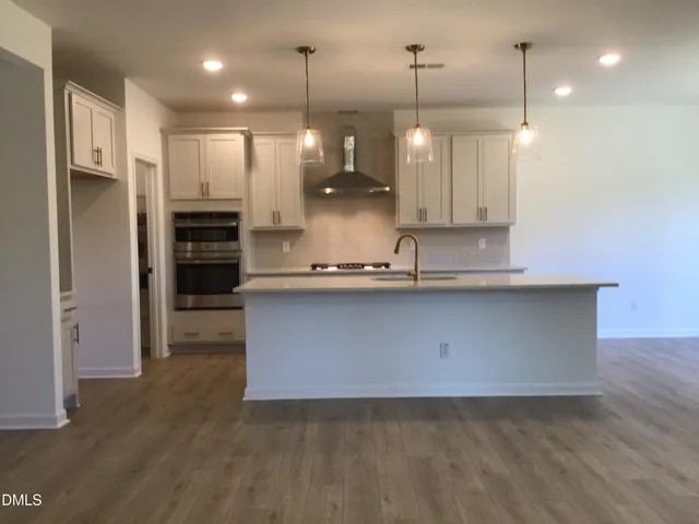 a kitchen with refrigerator a sink and cabinets