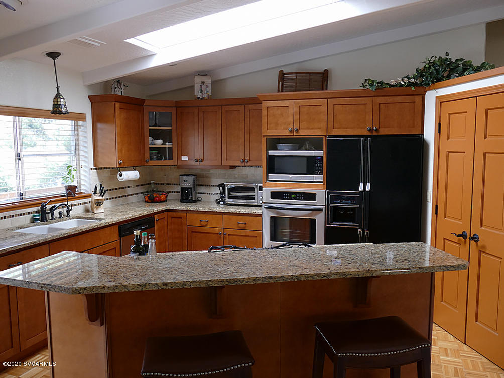 2275 Corral Road Sedona, AZ 86336 - Photo 12 of 30 a kitchen with stainless steel appliances granite countertop a sink stove and refrigerator