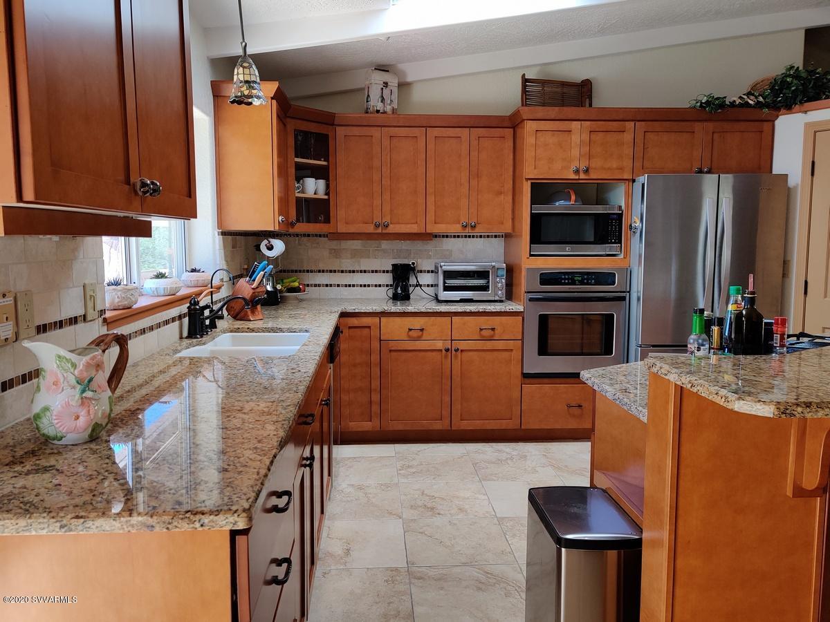 2275 Corral Road Sedona, AZ 86336 - Photo 14 of 30 a kitchen with stainless steel appliances granite countertop a sink a stove and a refrigerator