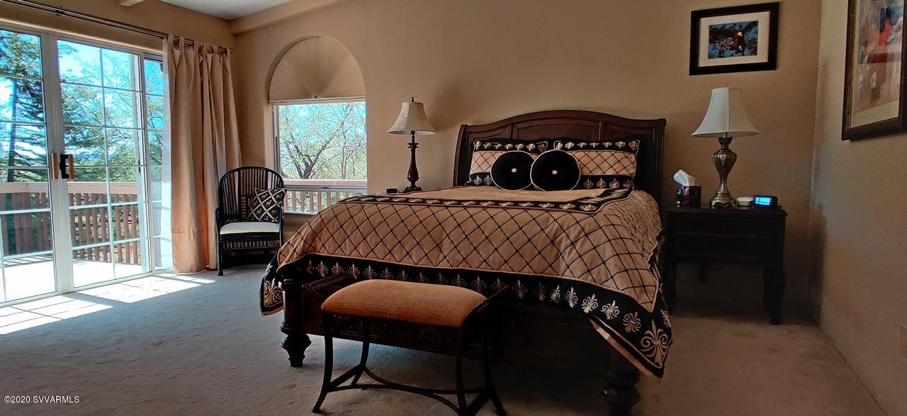 2275 Corral Road Sedona, AZ 86336 - Photo 22 of 30 a bedroom with a bed and a window