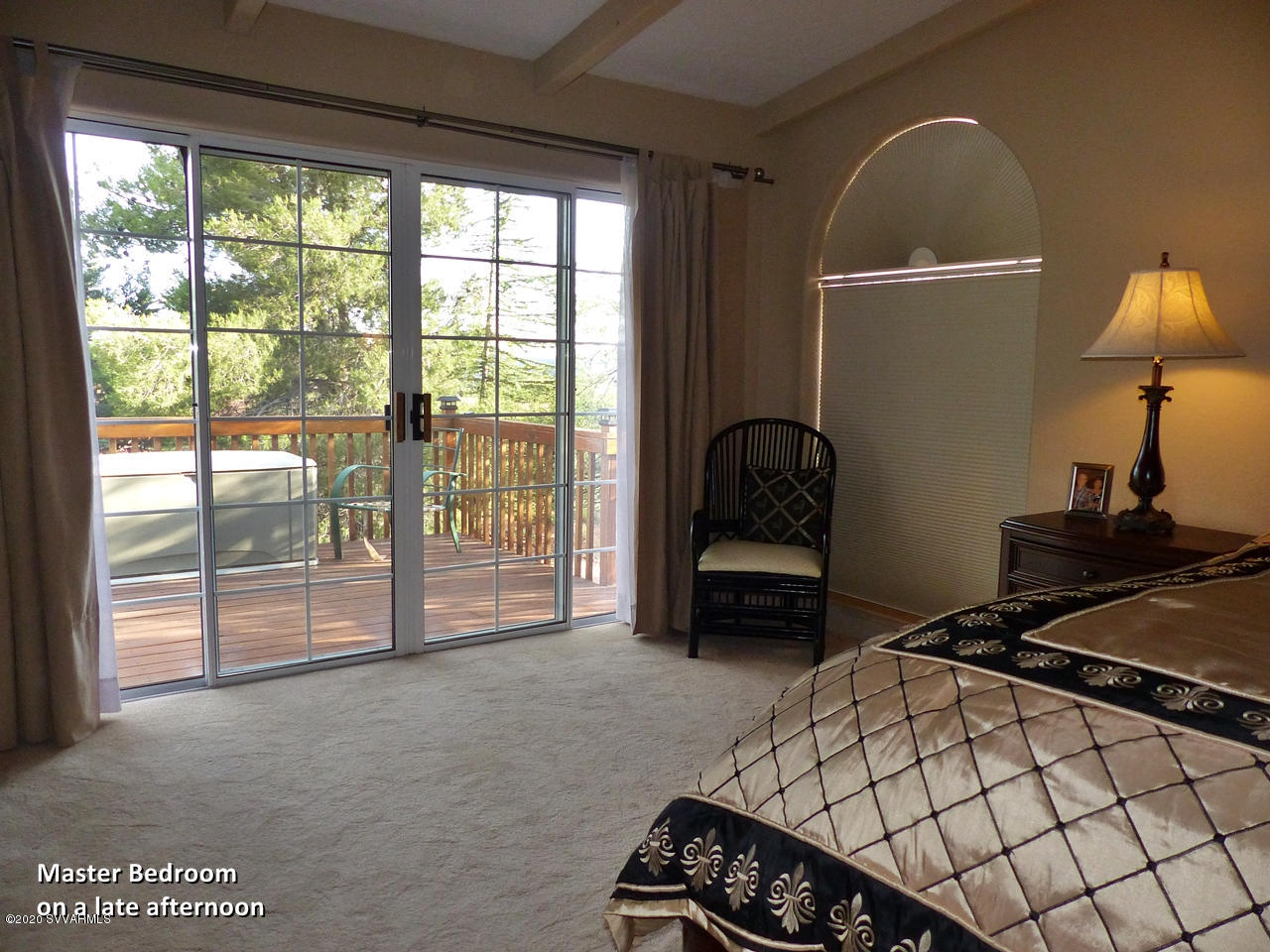 2275 Corral Road Sedona, AZ 86336 - Photo 23 of 30 a bedroom with a bed and a lamp next to a large window