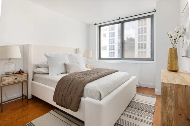 a kitchen with stainless steel appliances granite countertop a refrigerator a stove and a sink with wooden floor