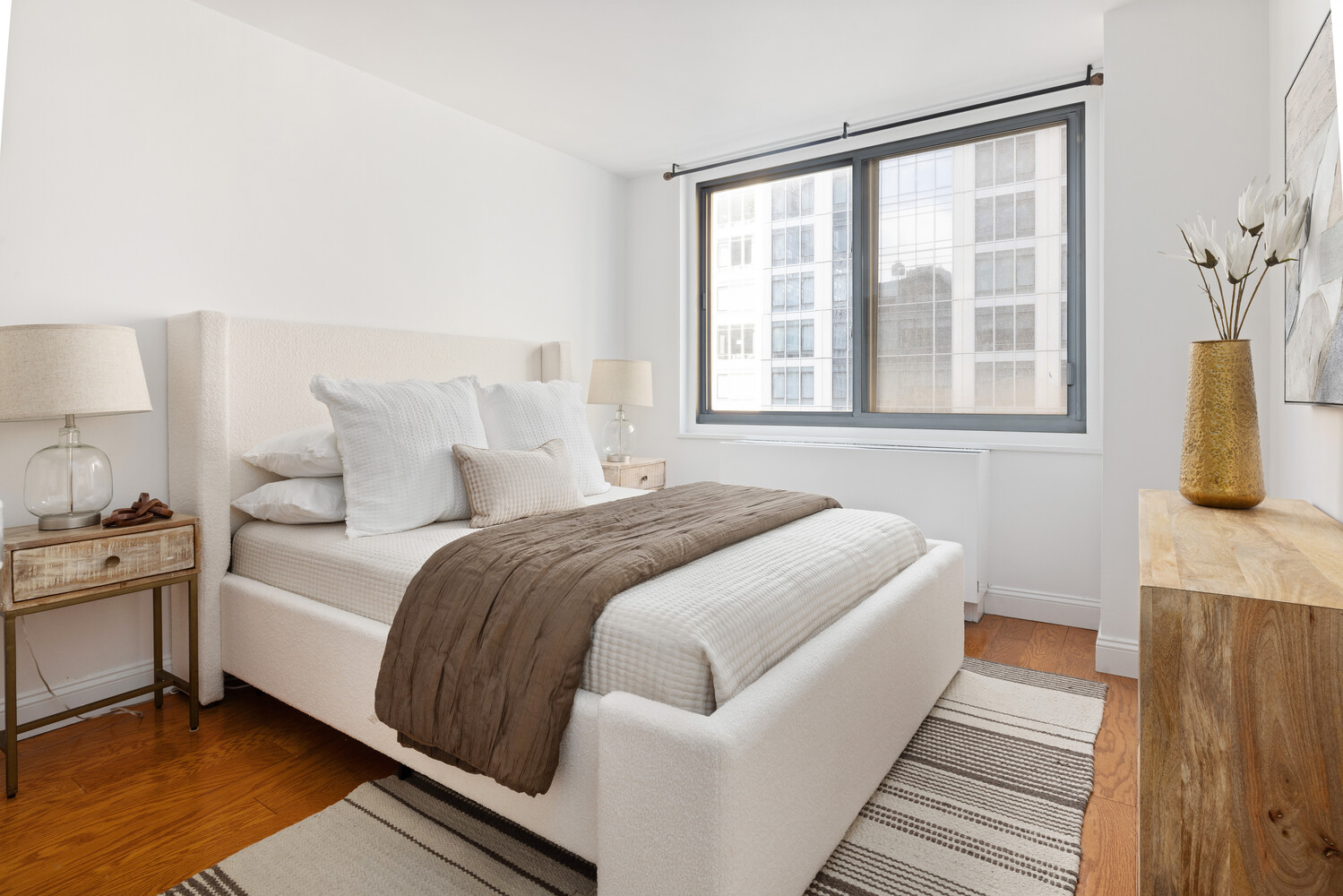 2025 Broadway, Unit 5C Manhattan, NY 10023 - Photo 4 of 10 a bedroom with a bed and wooden floor