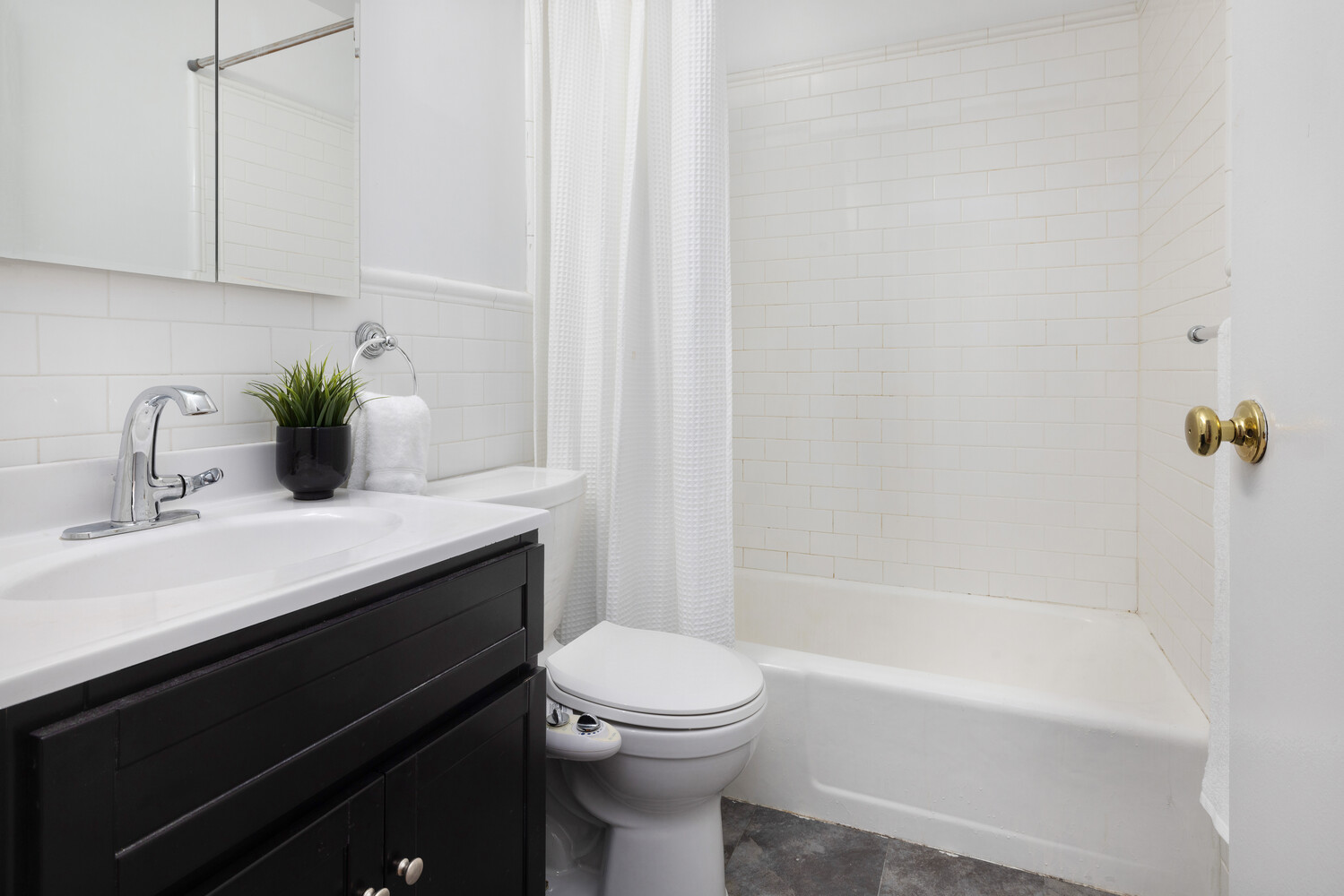 2025 Broadway, Unit 5C Manhattan, NY 10023 - Photo 5 of 10 a bathroom with a sink a toilet and shower