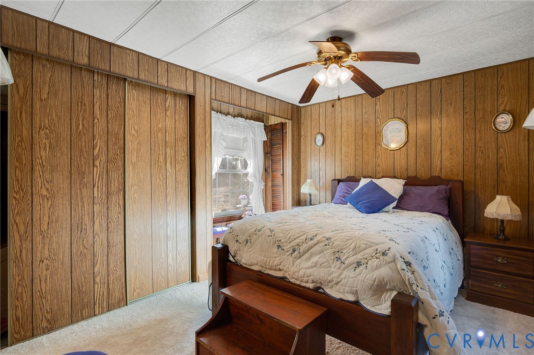 475 Dove Road Boydton, VA 23917 - Photo 13 of 45 a bedroom with a bed and a chandelier