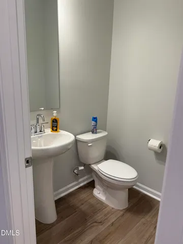 a white toilet sitting next to a bathroom sink
