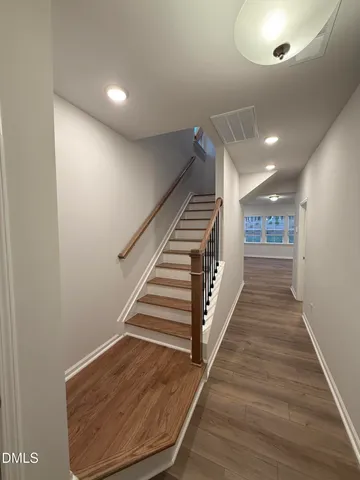 a view of a hallway with stairs