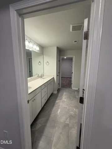 a bathroom with a double vanity sink mirror and double