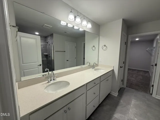 a bathroom with a glass shower door