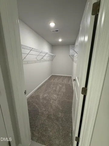 a view of an empty room and closet area