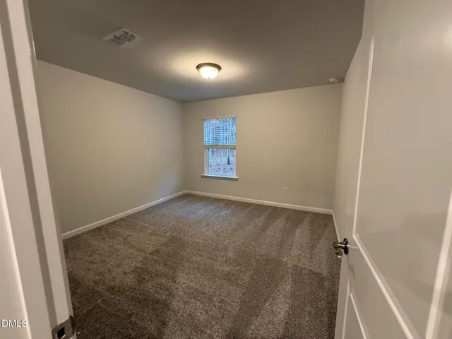 an empty room with a empty space and windows