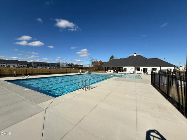 a view of a patio with iron fence