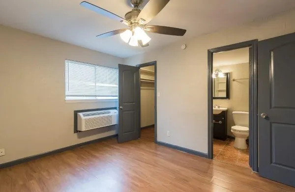 wooden floor in an empty room and a bathroom