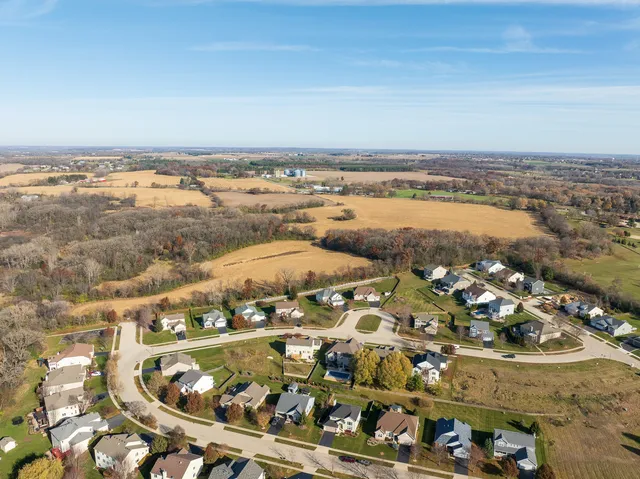 a view of a pool with lawn chairs and couches