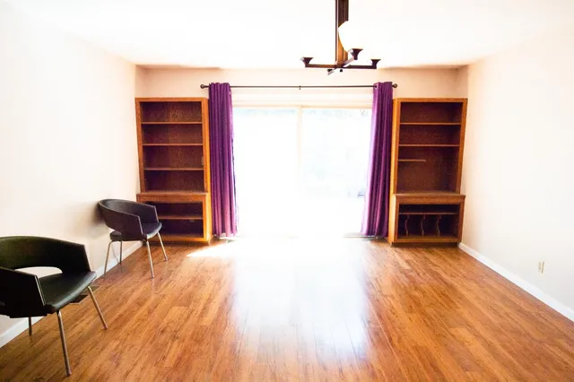 a view of a livingroom with furniture and staircase