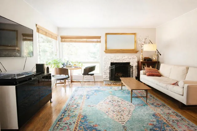 a living room with furniture fireplace and window