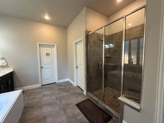 a bathroom with a shower and mirror