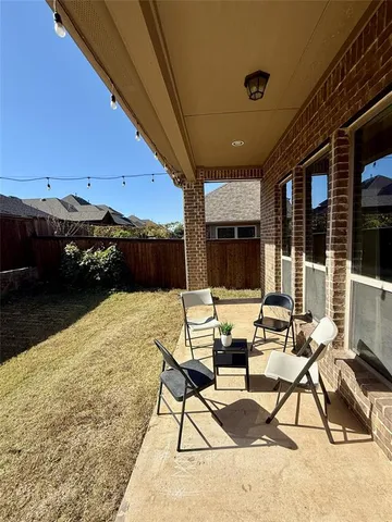 a building outdoor space with patio furniture and potted plants