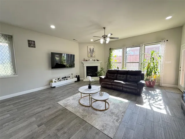 a living room with furniture a fireplace and a flat screen tv