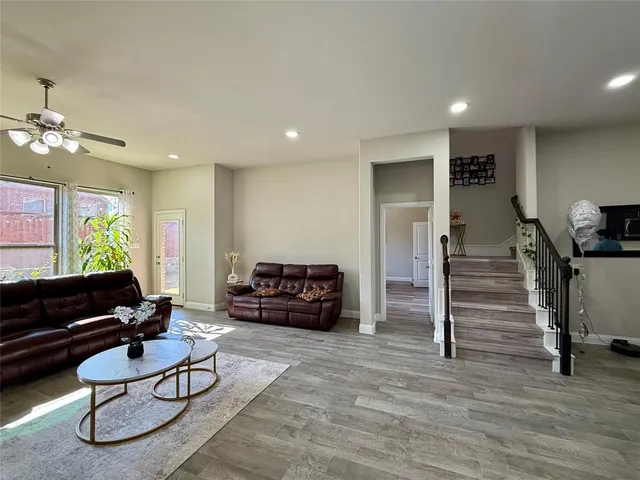 a living room with furniture and wooden floor