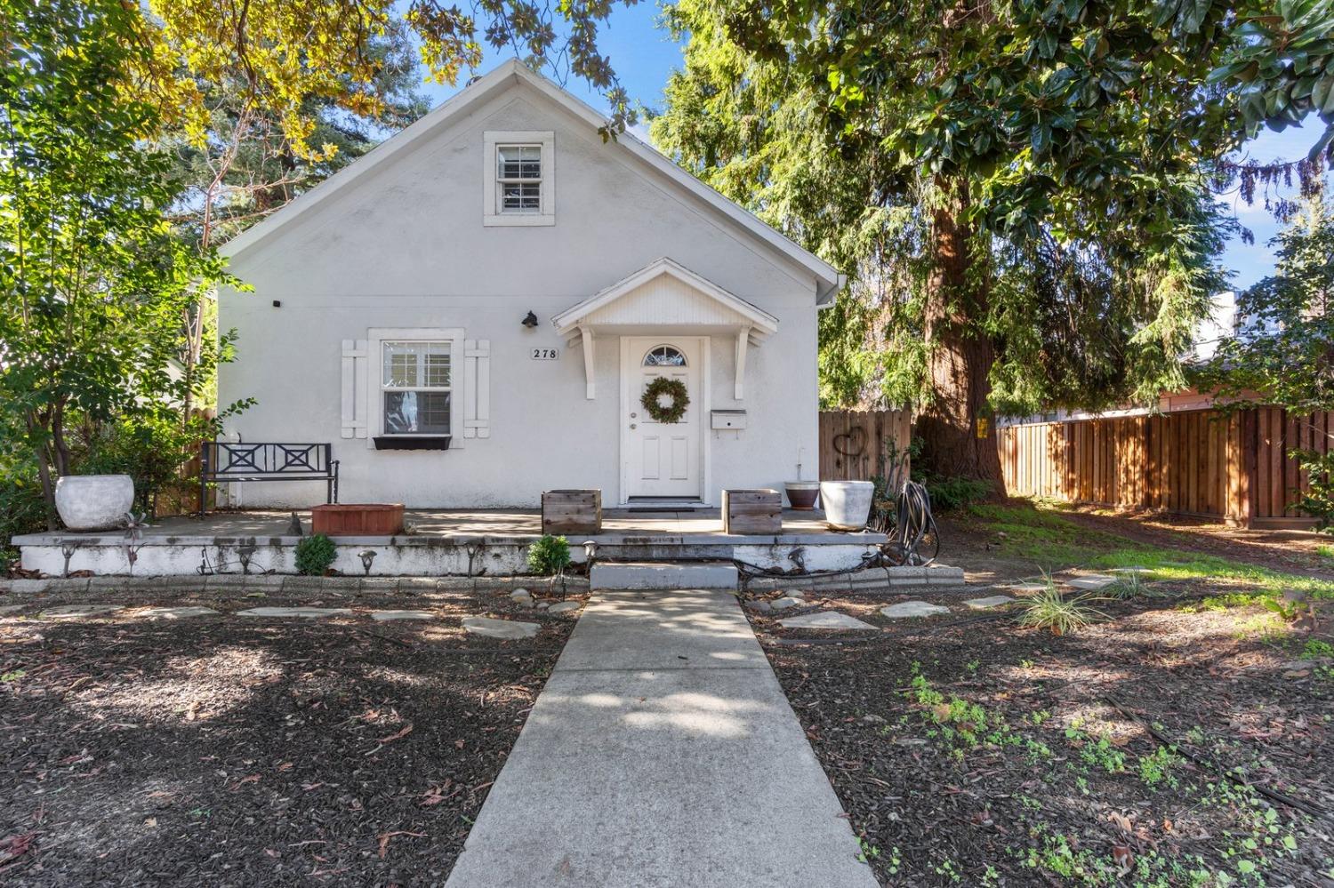 a view of a house with backyard and sitting area