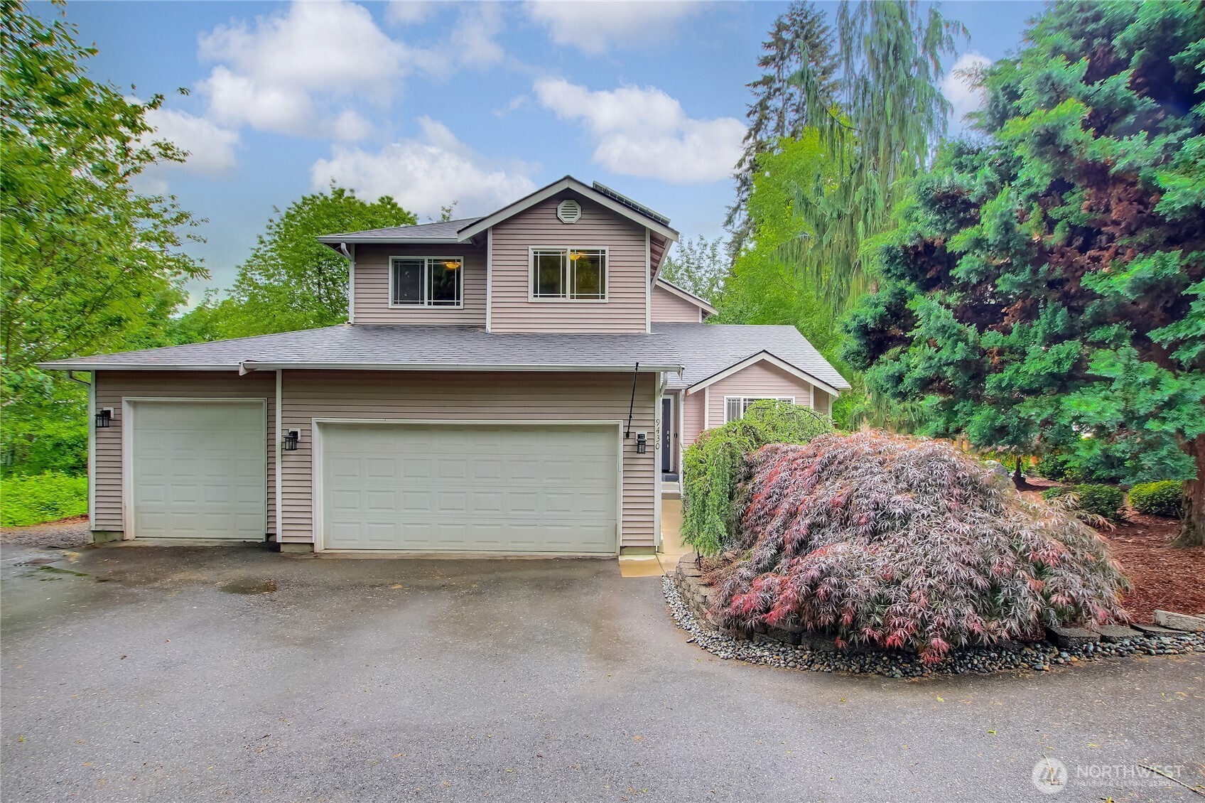 9430 Northeast 181st Lane Bothell, WA 98011 - Photo 1 of 25 a front view of a house with a yard and garage
