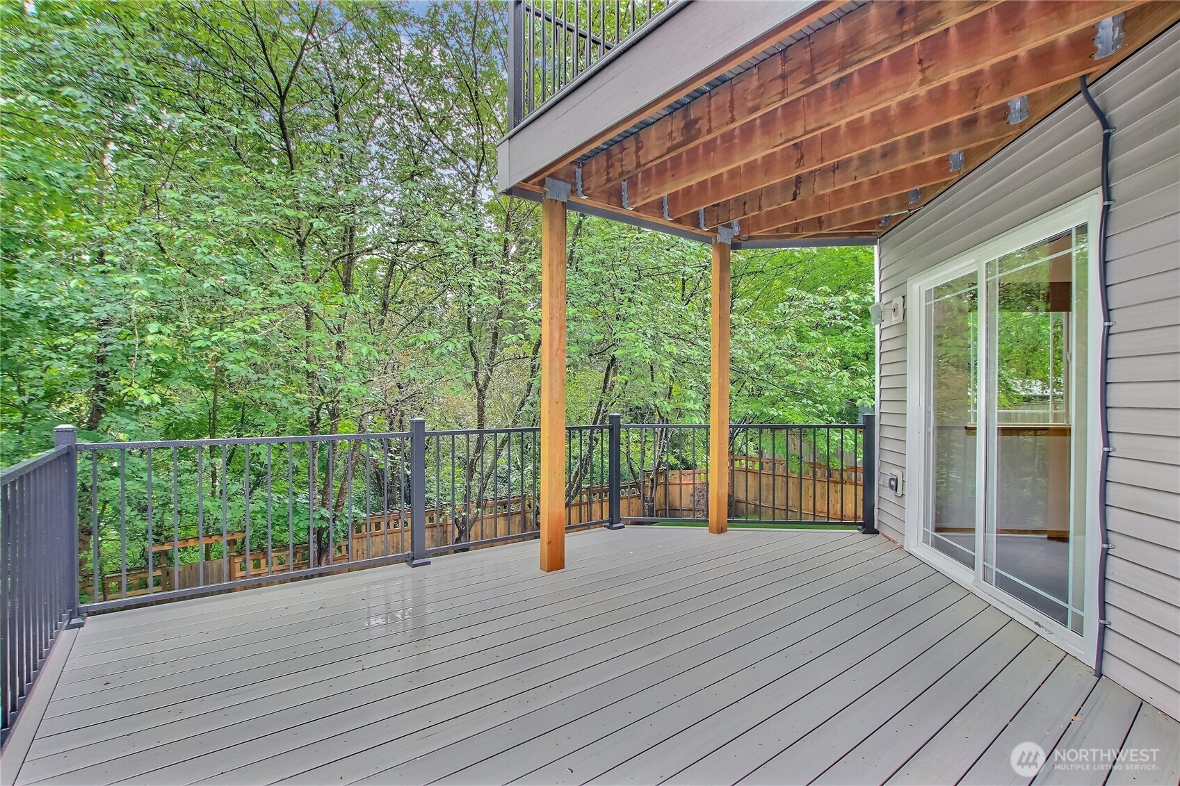 9430 Northeast 181st Lane Bothell, WA 98011 - Photo 12 of 25 a view of a backyard and floor to ceiling window wooden floor and fence