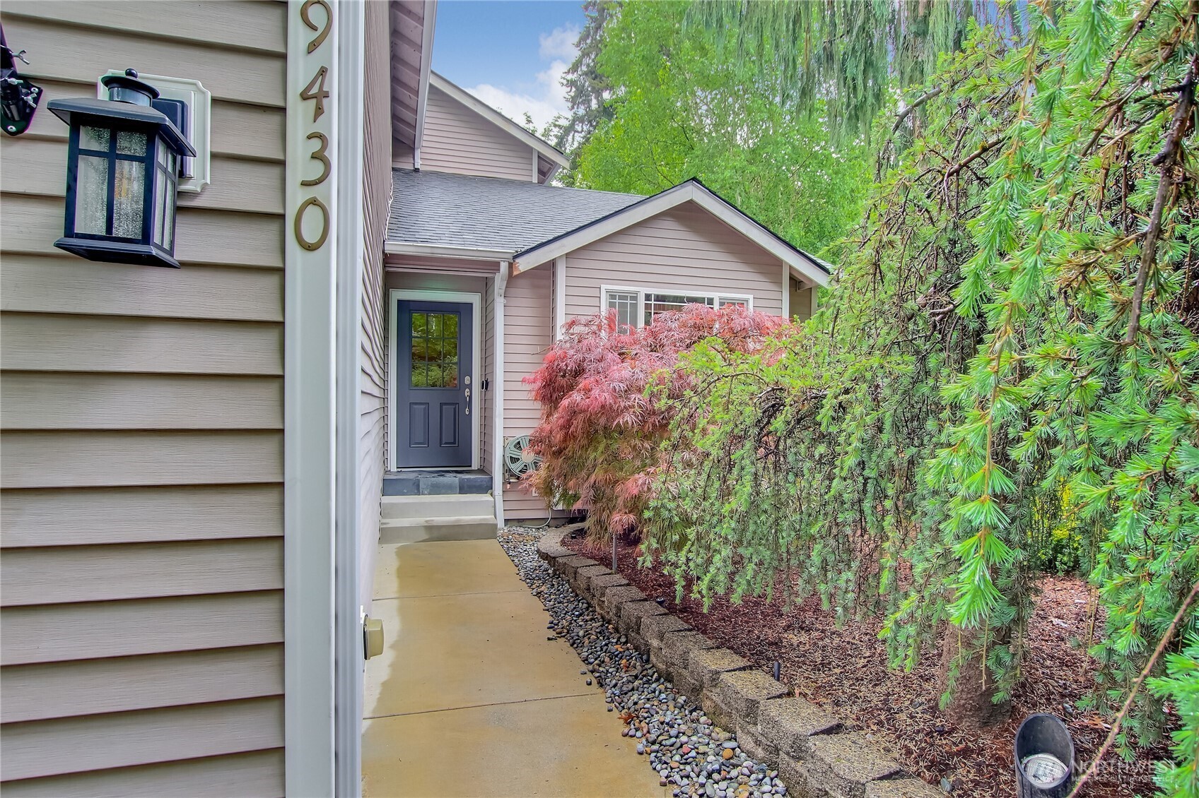 9430 Northeast 181st Lane Bothell, WA 98011 - Photo 2 of 25 a view of a house with a small yard