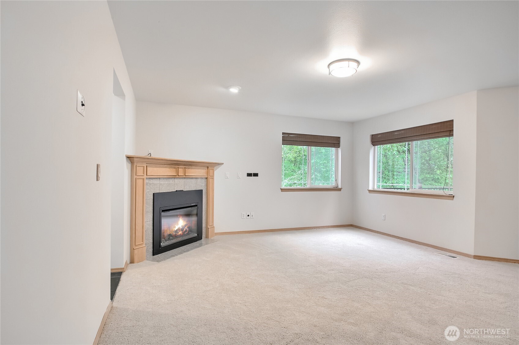 9430 Northeast 181st Lane Bothell, WA 98011 - Photo 3 of 25 an empty room with windows and fireplace