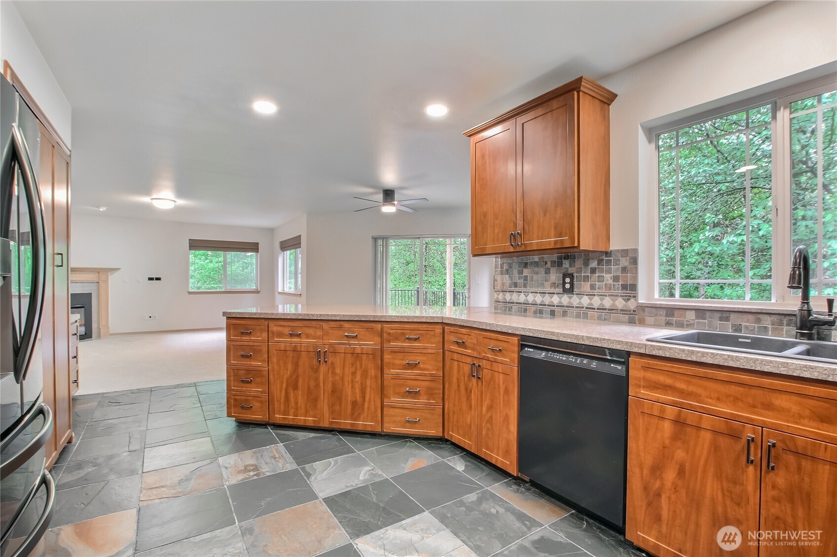9430 Northeast 181st Lane Bothell, WA 98011 - Photo 6 of 25 a large kitchen with kitchen island granite countertop a sink and a stove