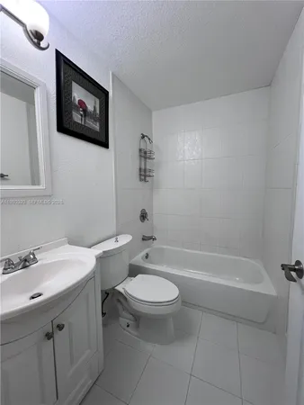 a bathroom with a toilet a sink and bathtub