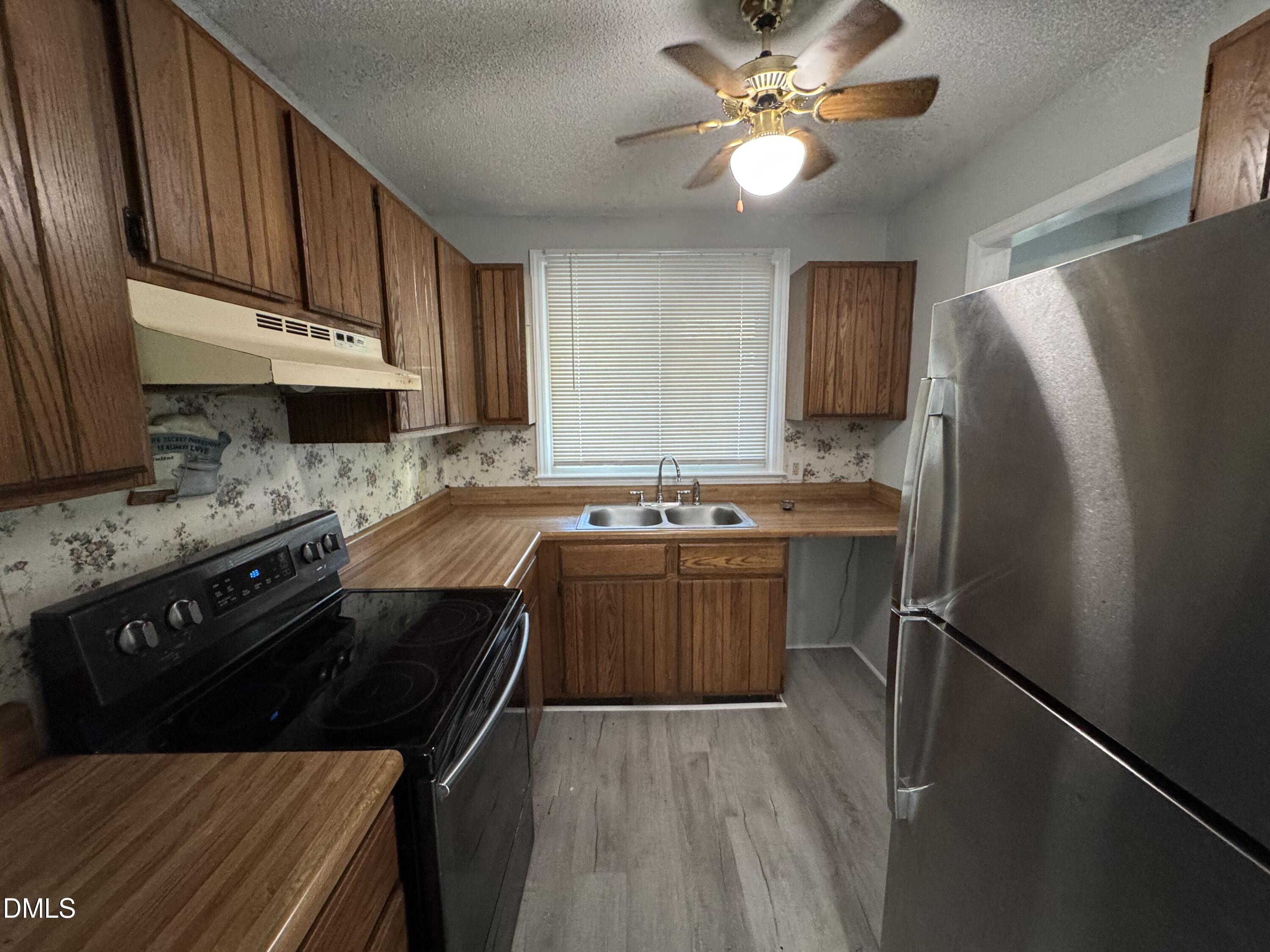 4200 Bertram Drive Raleigh, NC 27604 - Photo 2 of 16 a kitchen with stainless steel appliances granite countertop a sink stove and refrigerator