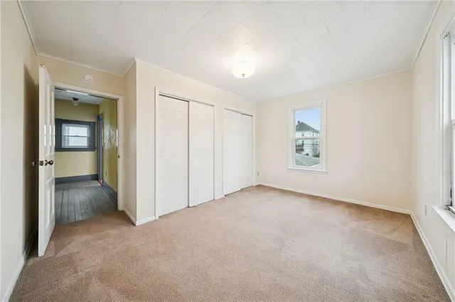 an empty room with windows and bathroom view