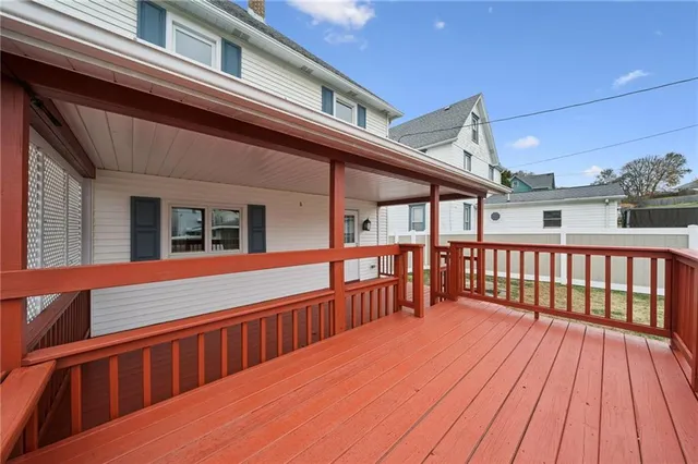 a view of wooden balcony with a barbeque