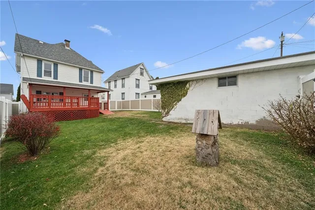 a front view of multi story residential apartment building with yard