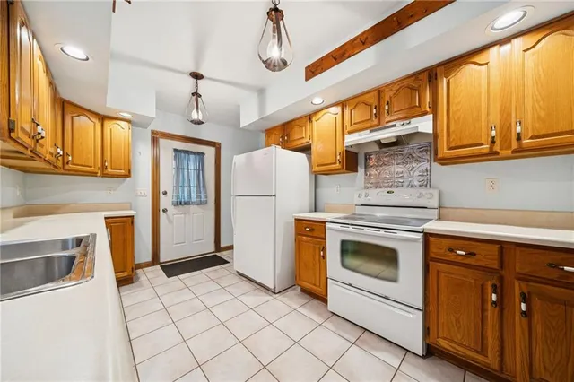 a kitchen with stainless steel appliances granite countertop a stove and a refrigerator