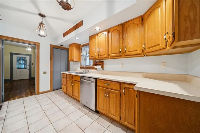 a kitchen with stainless steel appliances a sink a stove cabinets and a window