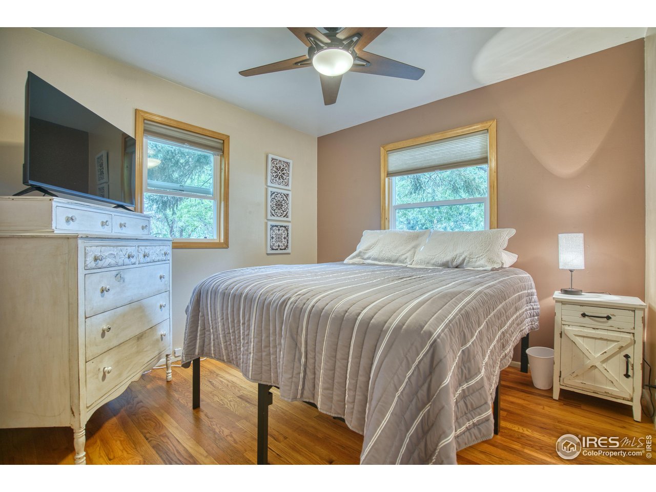 361 Delaware Street Sterling, CO 80751 - Photo 13 of 27 a bedroom with a bed and a chandelier
