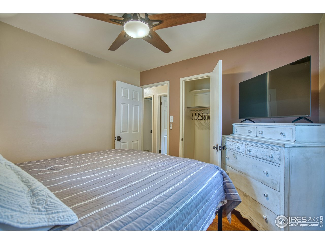 361 Delaware Street Sterling, CO 80751 - Photo 14 of 27 a bedroom with a bed and a flat screen tv