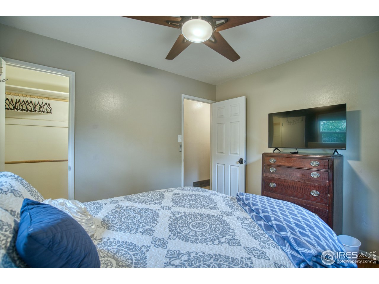 361 Delaware Street Sterling, CO 80751 - Photo 17 of 27 a bedroom with a bed and a flat screen tv